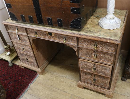 A late Victorian carved oak pedestal desk W.130cm